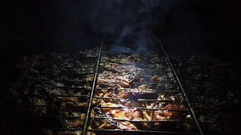 In the dark, meat is grilled on the grill. Stock Footage 115898769