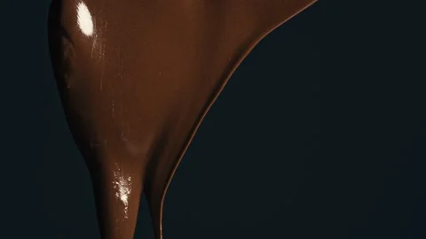 Dark melted chocolate flow. Slow motion Stock Footage 141306181