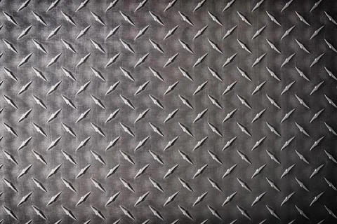 Dark metal texture with diamond pattern, abstract background. Stock Photos