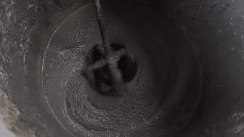 Dark mixture swirls within metal container Stock-Footage 342084877