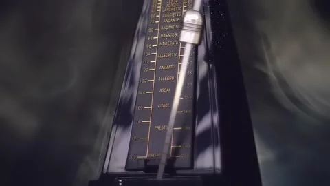 In the dark a modern metronome, with a swinging pendulum, in smoke Stock Footage 330858497