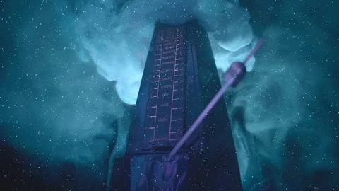 In the dark a modern metronome, with a swinging pendulum, in smoke Stock Footage 330887143