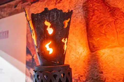 Dark, modern ornate lamp with angular shapes and patterned texture leaning .. Stock Photos