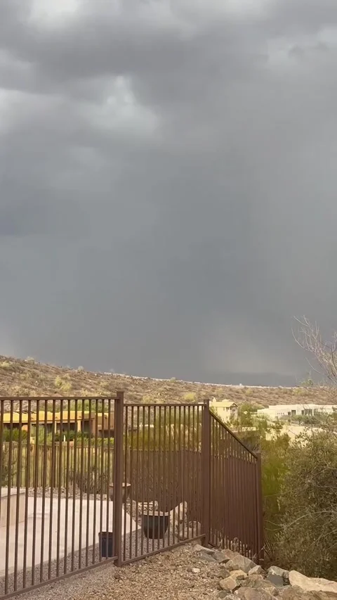 Dark Monsoon Storm Clouds Rolling Over Desert Pool and Hillside Stock Footage 339775994