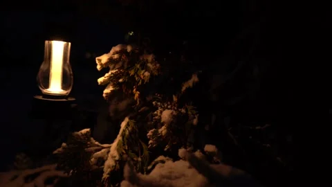 Dark mood created by camping light coming and going from a bush glowing light Stock Footage 146420074