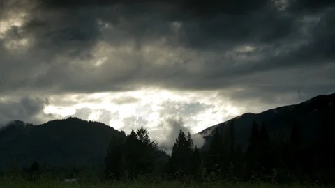 Dark, moody scenic of clouds passing over mountains. Stock Footage 86757784
