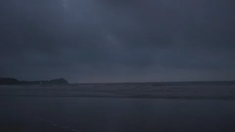 Dark moody sea under heavy overcast sky with distant shoreline.beach, waves Stock Footage 336796841