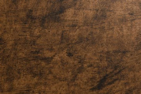 Dark, mottled brown background with subtle scratches and textures Illustrazione stock