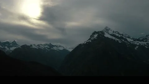Dark mountain peaks with cloud covering the sun Video stock 140610841