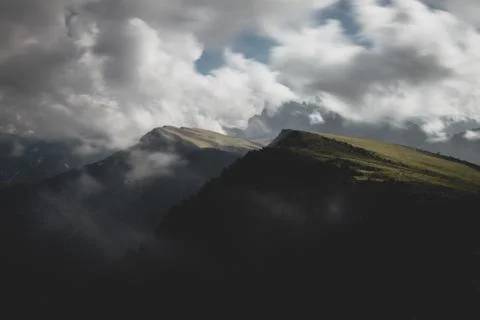 Dark mountain range with moving clouds Stock Photos