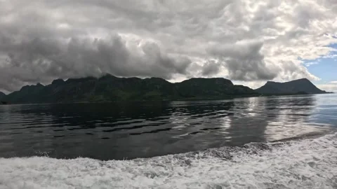 Dark mountain range under heavy overcast sky in Lofoten Vidéo 344753129