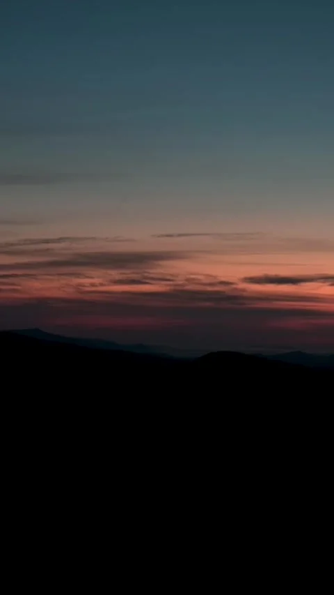 Dark mountain silhouettes under a vibrant dusk sky on Roan Mountain, USA. The Video stock 286250090