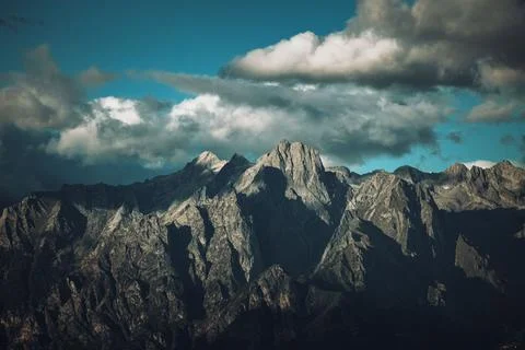 Dark mountain with sun rays hitting the peak on a semi-cloudy day.
Good for a de 스톡 사진