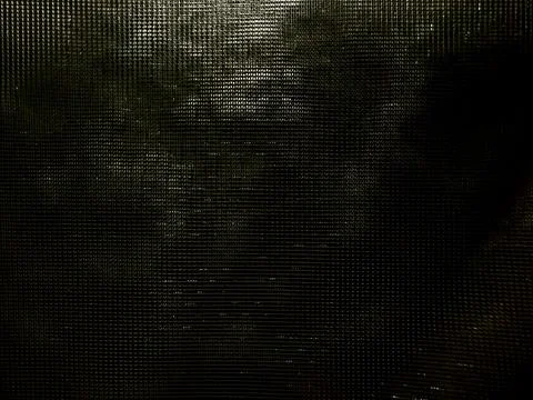 Dark mysterious grid mesh texture faintly glowing in shadowy black void abs.. Stock Photos