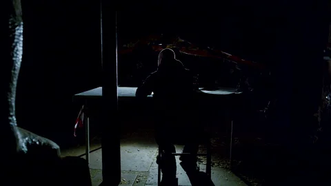man sitting in the dark