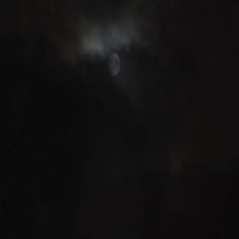 A dark night with eerie clouds pass over a super moon. Stock Footage 69672294