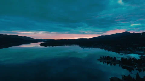Dark night sky over Big Bear Lake with quiet mountains and subtle water 库存影片 328899317