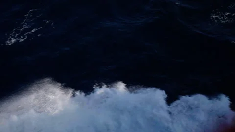 Dark ocean surface at night, with soft waves and rippling textures across deep Video stock 316774793