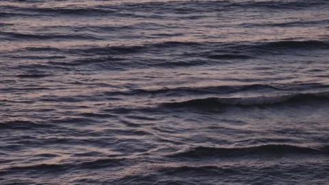 Dark ocean waves moving on a summer sunset or sunrise at sea Vídeo Stock 345653604