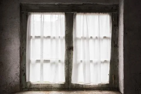 Dark old window with bricks and curtain, light coming through Stock Photos