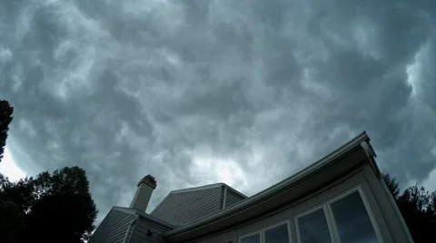 Dark Ominous Clouds moving through sky over house Stock Footage 58968649