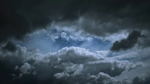 Dark ominous storm clouds with a break of light in the center Stock Footage 341373402