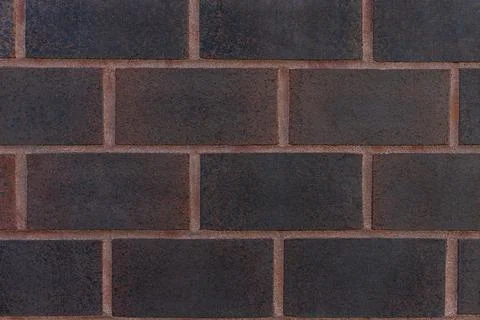 Dark orange brick wall texture background close-up. Stock Photos