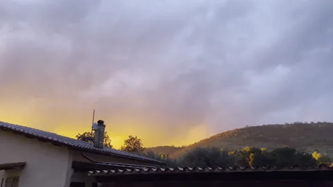 Dark orange cloud moving along the sky after strong thunderstorm, countryside Stock Footage 313341252