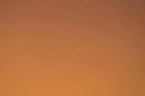 Dark orange gradient background, shot of the sky at sunset. Abstract blank .. Stock Photos