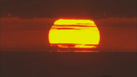 Dark orange sunset, Big Close Shot Of Sunset, Then Covered By Mountain From Stock Footage 108599276