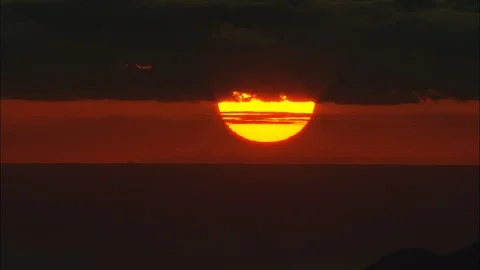 Dark orange sunset, Close Shot Setting Covered By Mountain Stock Footage 108599266