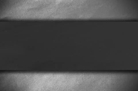 Dark paper on a white wall Fotos Stock