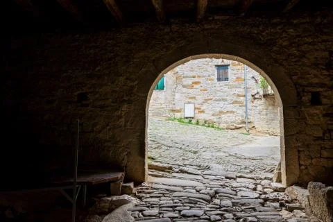 Dark passageway with arch to the light Фото