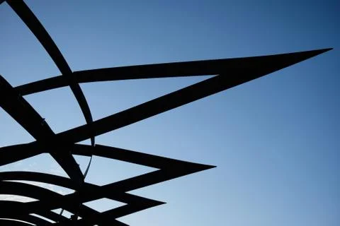 Dark patterned metal structure against the blue sky 스톡 사진