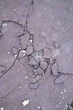 Dark pavement shows extensive cracking Stock Photos