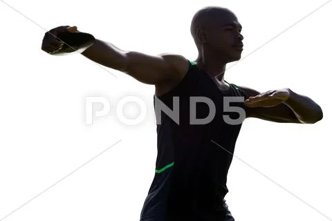 Dark picture of sportsman is practising discus throw Stock Photos