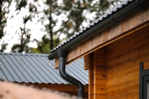 Dark plastic drainage system of a private house. Drainage system under the .. Stock Photos