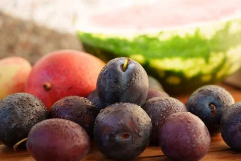 Dark plums with water drops Stockfoto's