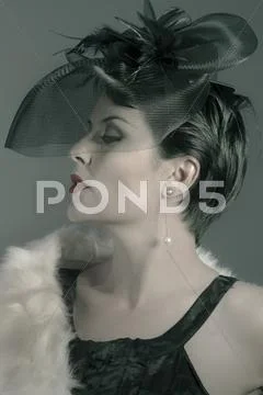 Dark portrait of a beautiful young widow dressed in a haute couture black out Stock Photos