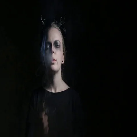 Dark portrait of evil witch with vaporizer. 4K UHD Видео 69412082