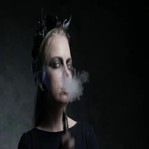 Dark portrait of evil witch with vaporizer. 4K UHD Stock Footage 69413345