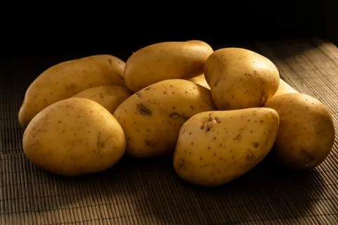 Dark potatoes scene Stock Photos