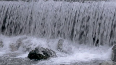 Dark, powerful waterfall with lots of water spray Stock Footage 83119985