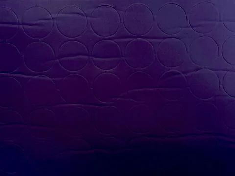 Dark purple abstract background with repeating embossed geometric circles on  Foto stock