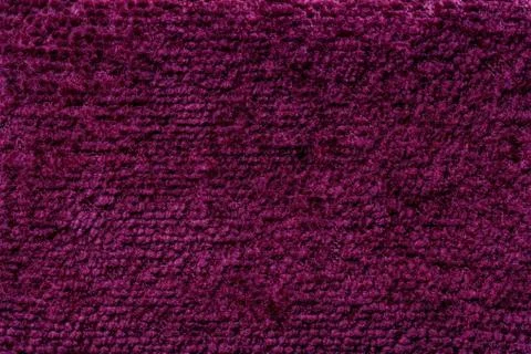 Dark purple fluffy background of soft, fleecy cloth. Texture of textile close Stock Photos