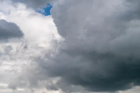 Dark rain cloud advancing over sky, towering nimbus mass with deep shadows .. Stock Photos