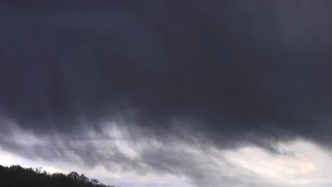 Dark rain cloud and heavy downpour on a green hillside. 스톡 동영상 338353950
