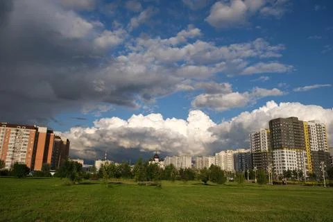 Dark rain clouds against the background of the Moscow sleeping area. Stock Photos