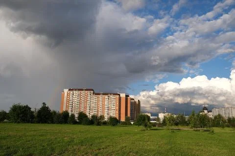 Dark rain clouds against the background of the Moscow sleeping area. Stock Photos