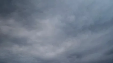 Dark rain clouds in the evening sky, timelapse. Dramatic sky with an coming c Stock Photos